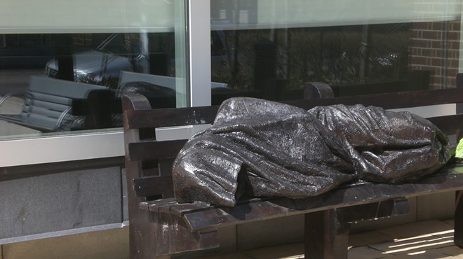 Homeless Jesus sleeping on a bench statue to be installed where homeless aren't allowed to sleep on benches