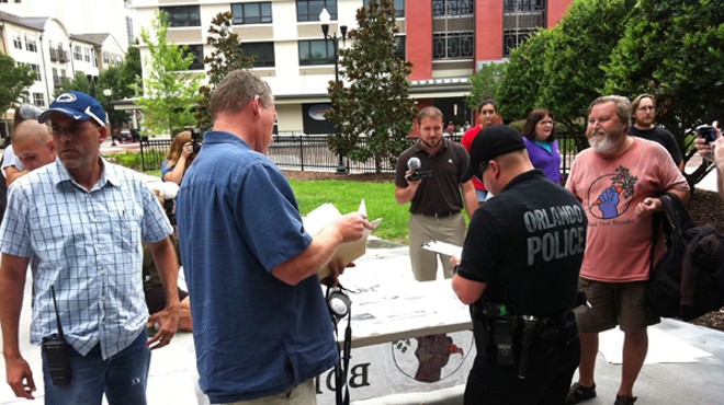 Slurred speech? Food Not Bombs members share food at a public feeding at Lake Eola Park on June 16