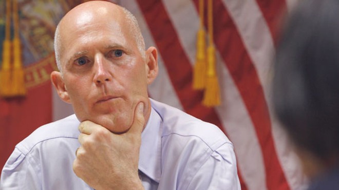 "Some hesitation": Gov. Rick Scott signs online voter registration bill, but does so with a frown