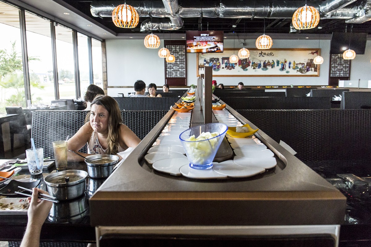 Nine Spices Hotpot, featuring an all-you-can-eat conveyor-belt, is a chaos of flavors and textures