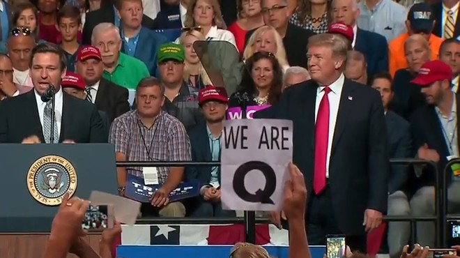 Conspiracy theory group QAnon made an unusually large debut at Trump's Tampa rally