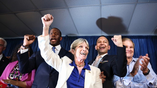 Florida Democratic Party chairwoman Terrie Rizzo chants "Bring it home!" with gubernatorial nominee Andrew Gillum (left), State Rep. Carlos Smith, and U.S. Sen. Bill Nelson (far right) to conclude a Democratic victory rally in Orlando on Aug 31 2018.