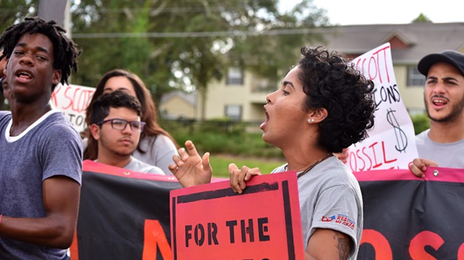 Protester boos Rick Scott over his environmental record in Orlando on Sept. 18, 2018