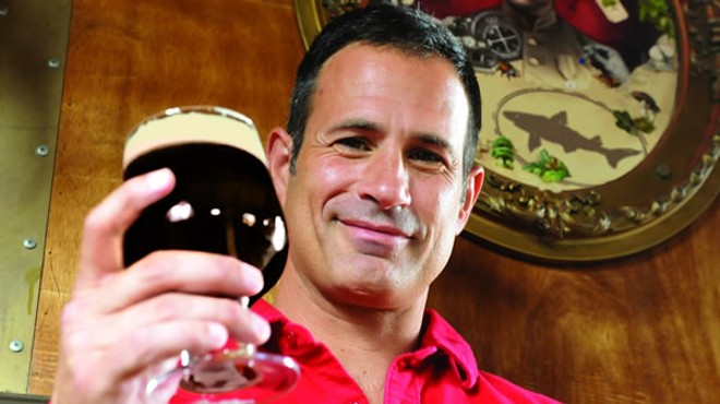 Sam Calagione, founder and president of Dogfish Head Craft Brewery, raises a glass