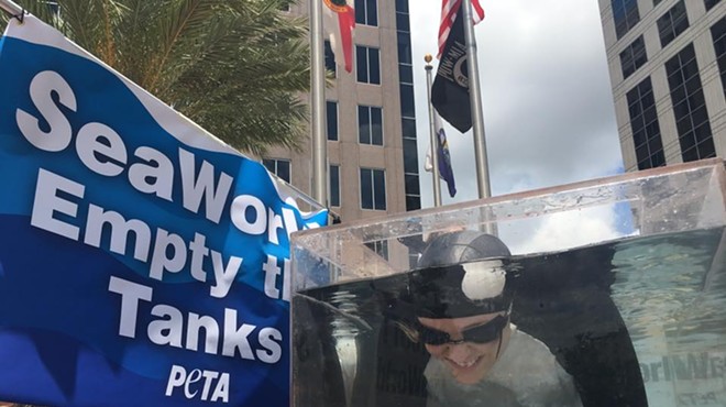 PETA protests SeaWorld in downtown Orlando by putting orca-woman in tiny water tank