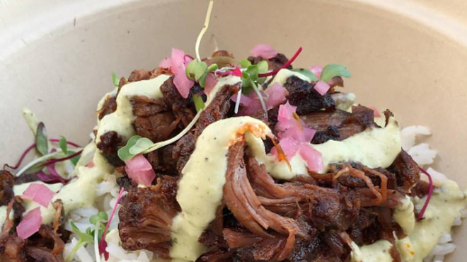Braised short rib over rice with pickled onions and aji verde.