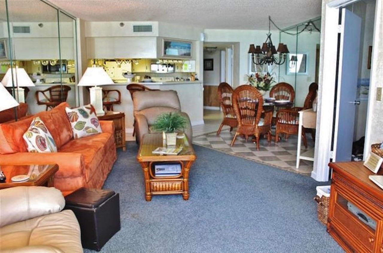  Check out this well-situated condo near Daytona International Speedway
Average night $167 
2 bedrooms
There's plenty of chair and sofa space if you and your gang are relaxing after a day out in the sun.