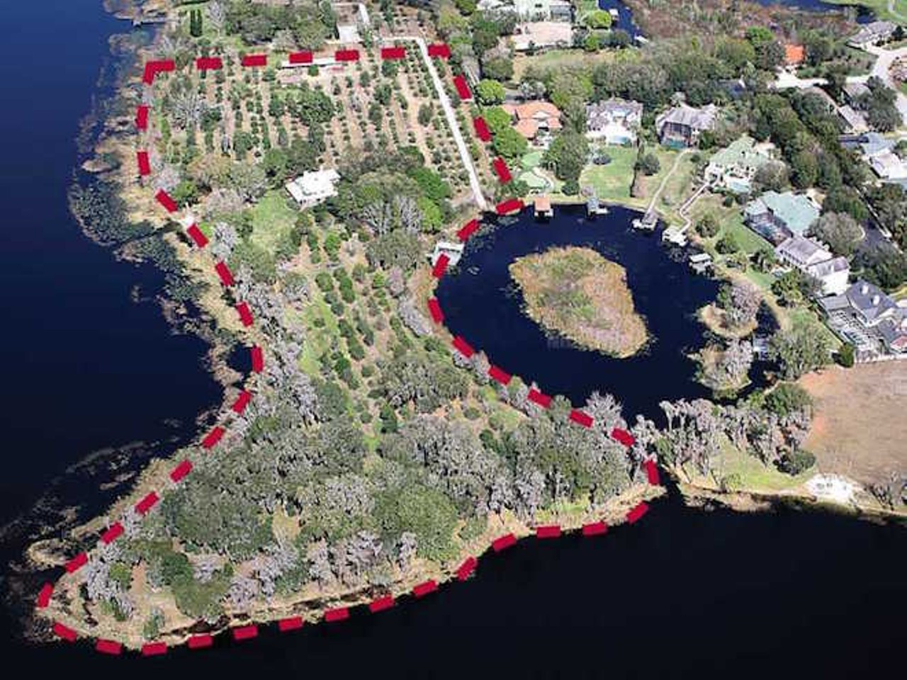 It is its own peninsula with multiple residences, sandy lakefronts and 12.5 acres to roam (or develop). And you can own it all for $12,500,000.