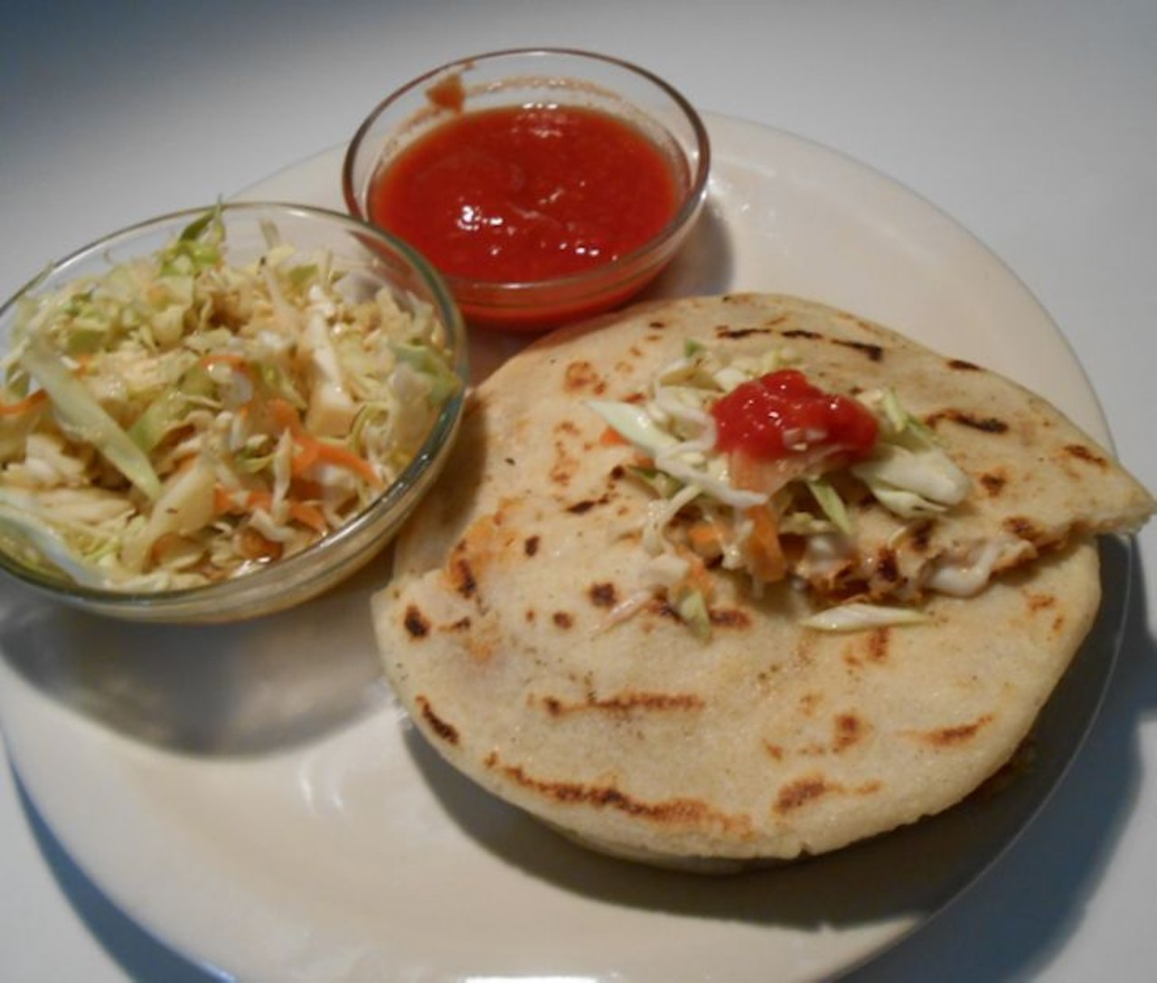 What we recommend: pupusa revuelta 
For those who love pork and cheese, this soft tortilla dish topped with spicy curtido cole slaw is sure to hit the spot. It's easy to see why pupusas are a Central American favorite.
Photo via www.pupuseriamaya.net