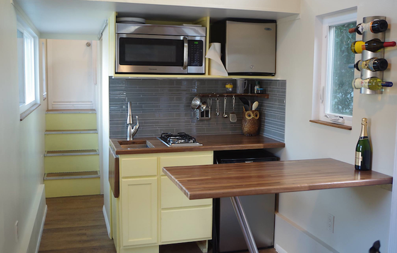 Little Sunshine
Location: Leesburg
Price: $59,000
Size: 225 sq. ft.
With pastel yellow and beautiful wood, the name Little Sunshine definitely suits this mobile home. The kitchen area overlooks the spacious living room area.
