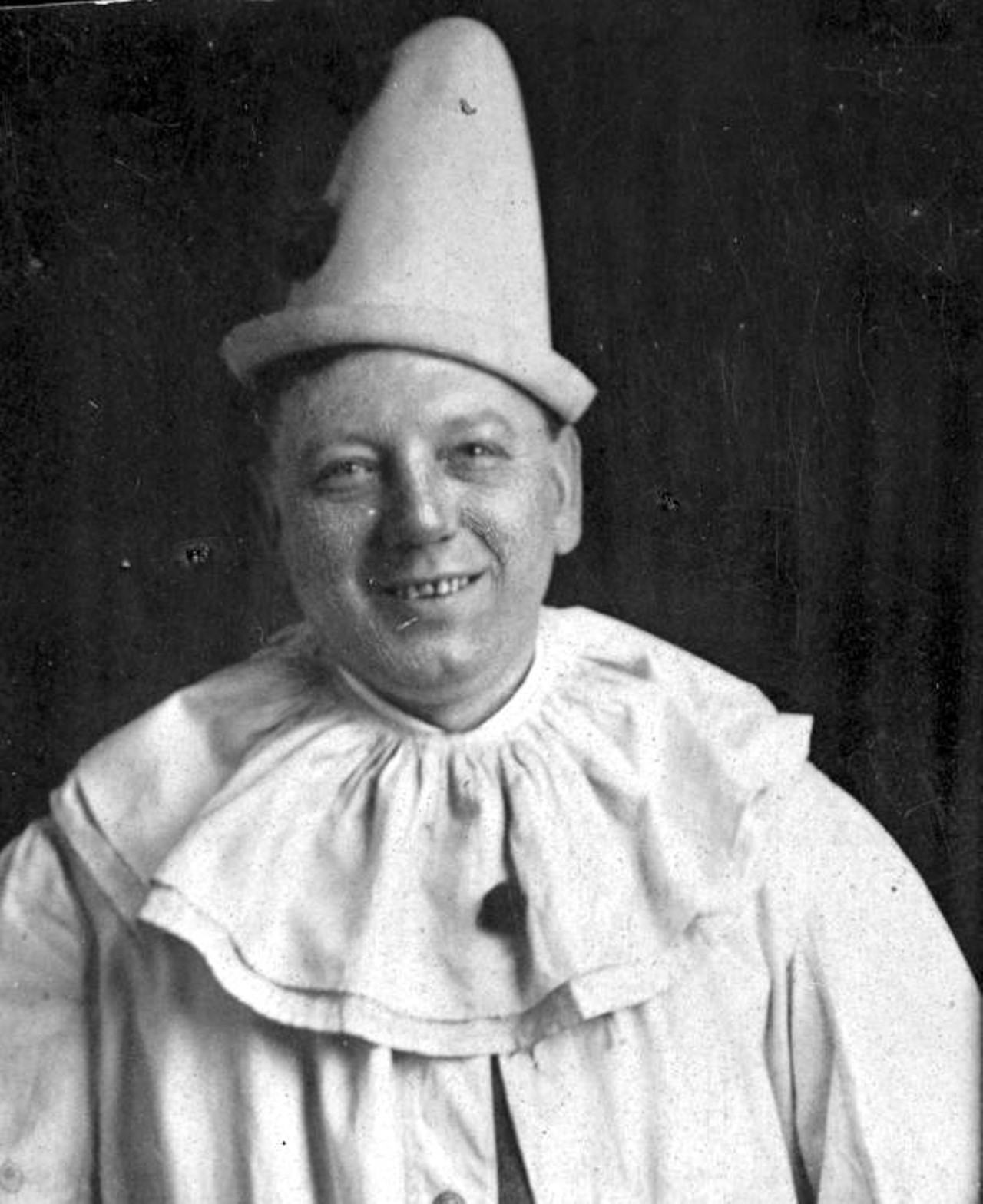 An unidentified smiling man in a clown outfit, circa 1920s (via floridamemory.com)