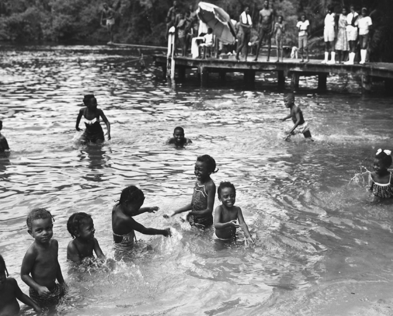 Family members gather on the dock over the Silver River to watch over the children swimming at Paradise Park. Photo by Bruce Mozert. By permission of Bruce Mozert. Courtesy of the Marion County Black Archives. Reprinted with permission of the University Press of Florida.