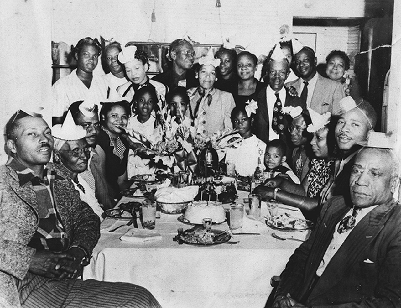 The Vereen family celebrates a birthday at their home. Eddie Vereen is seated at the rear right corner of the table with his grandson Reginald Lewis in his lap. Arizona Vereen-Turner is standing near the rear left corner. By permission of Henry Jones. Reprinted with permission of the University Press of Florida.