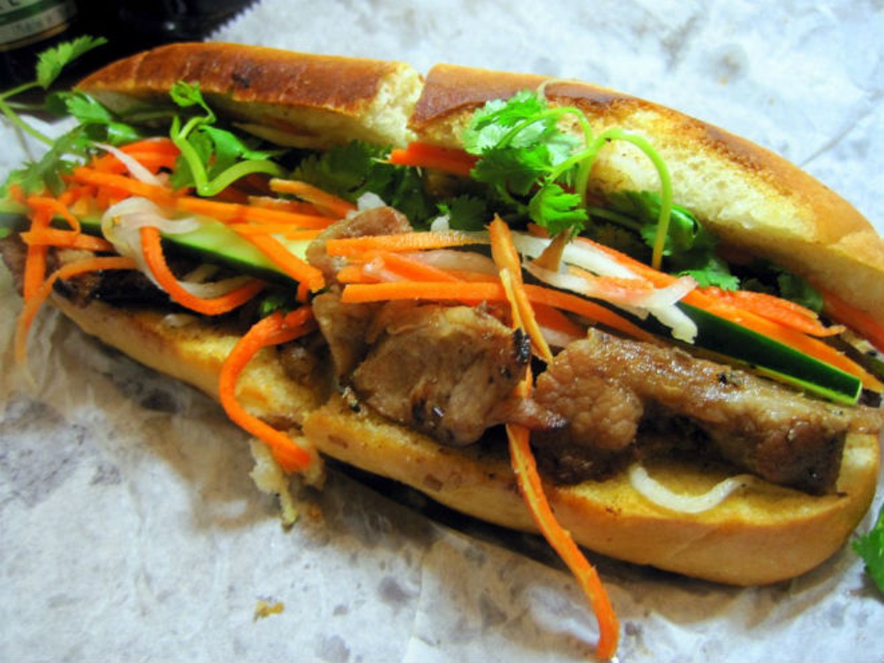 Anh Hong 
1124 E. Colonial Drive, 407-999-2656
Even within the tough competition of Mills 50, the Anh Hong special banh m&iacute; is a cut above: ham, p&acirc;t&eacute;, sausage, pork, headcheese and pickled vegetables on buttered French bread for just $2.95 (if you're squeamish about variety meats, choose the sunnyside-up egg sandwich for $3.50). Add a Vietnamese iced coffee for $2.75 and this is still the cheapest lunch of the bunch.
Photo via Yelp