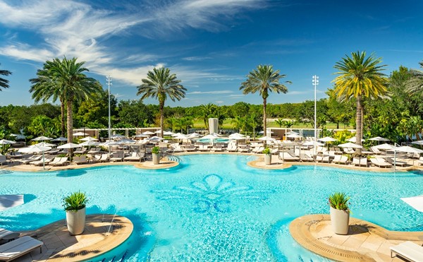 The Ritz-Carlton Orlando, Grande Lakes
4012 Central Florida Parkway, Orlando
Price: Starts at $59
This resort’s bright pink chairs, waterfall and chill atmosphere whisks its guests away from the hustle of Orlando. The pool doesn’t close until 11 p.m., so it’s the ideal spot for a daycation on the water. Food and drink services are available until 1 p.m. A day pass purchase also includes free parking and Wi-Fi.