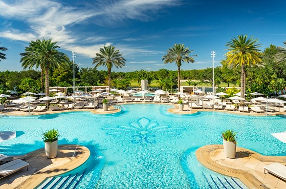 The Ritz-Carlton Orlando, Grande Lakes
4012 Central Florida Parkway, Orlando
Price: Starts at $59
This resort’s bright pink chairs, waterfall and chill atmosphere whisks its guests away from the hustle of Orlando. The pool doesn’t close until 11 p.m., so it’s the ideal spot for a daycation on the water. Food and drink services are available until 1 p.m. A day pass purchase also includes free parking and Wi-Fi.