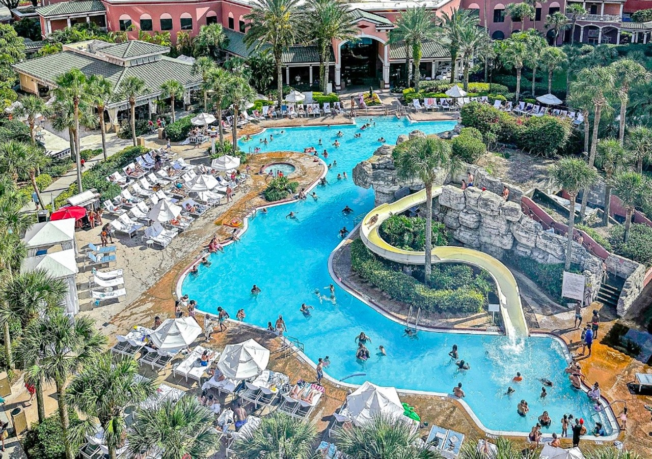 Caribe Royale Orlando
8101 World Center Drive, Orlando
Price: Starts at $45
With the purchase of a day pass here you’ll get discounted parking and access to the large resort-style pool and waterslide. And if you get lucky, there are some lounge chairs that sit below a cave with a view of a waterfall.
