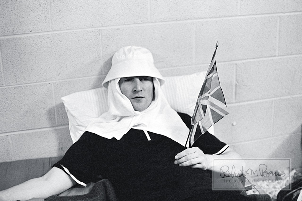John Lennon Backstage, Memorial Coliseum, Portland, Oregon, August 22, 1965 #1With many of the Beatles&#146; second US tour dates being grueling double-headers, the boys often found strange ways to entertain themselves between shows, as this photo of John Lennon dressed as Lawrence of Arabia showcases.