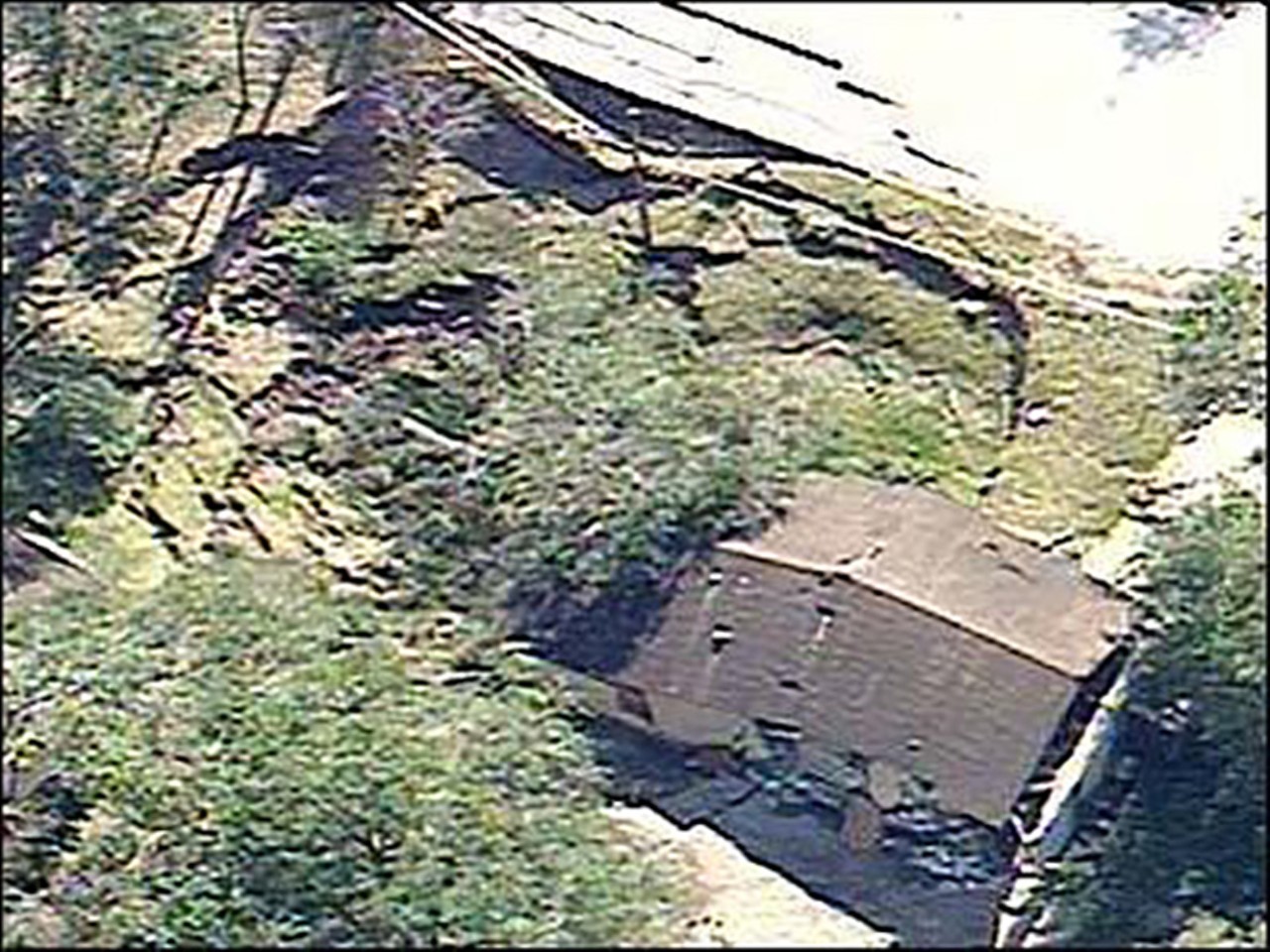 Massive sinkhole opens up in Orange City, Fla.
January 10, 2005
A 110-foot wide sinkhole completely destroyed the home of a young mother in Orange City, Fla. while also heavily damaging the neighboring house. Luckily, the mother and her baby weren't home when the sinkhole opened up.
Photo via wftv.com