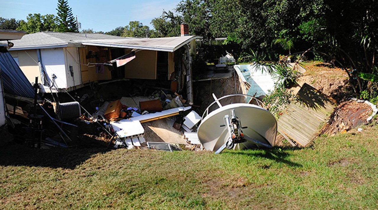 Swimming pool and boat eaten by sinkhole in Dunedin, Fla.
November 14, 2013
Nothing brings people together like a sinkhole. This 70-foot wide sinkhole sucked one home's porch and 14-foot boat into its depths. The sinkhole also destroyed the neighbor's master bedroom and swimming pool. City officials condemned both homes and evacuated six other houses.
Photo by Luke Johnson via nbcnews.com
