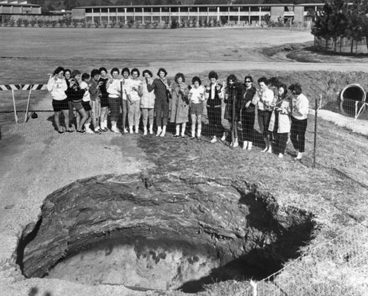 Sinkhole spotted at Florida State University in 1962
January 18, 1962
Female students from Florida High School took a break from their soccer game to look at this limestone sinkhole forming on FSU&#146;s campus. A state geologist at the time claimed that a sinkhole like this 26-footer &#147;might not be seen again in a half century.&#148;  That geologist was wrong. 
Photo via State Archives of Florida