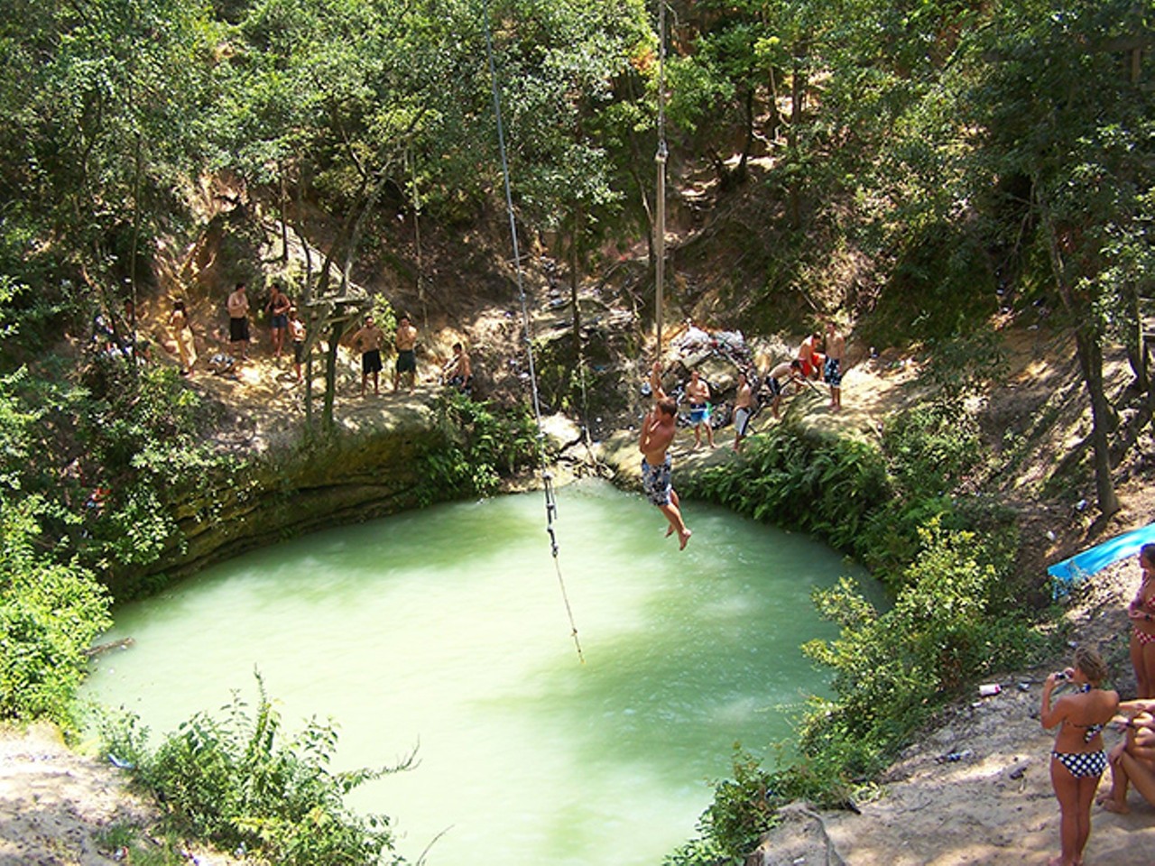 Devil's Hole in Hawthorne, Fla.
Before the landowners posted no trespassing signs along the surrounding area, tourists could plunge into the sinkhole's murky green water thanks to a rope swing at the top of the vegetation. Kowabunga into Hell!
Photo via roadtrippers.com