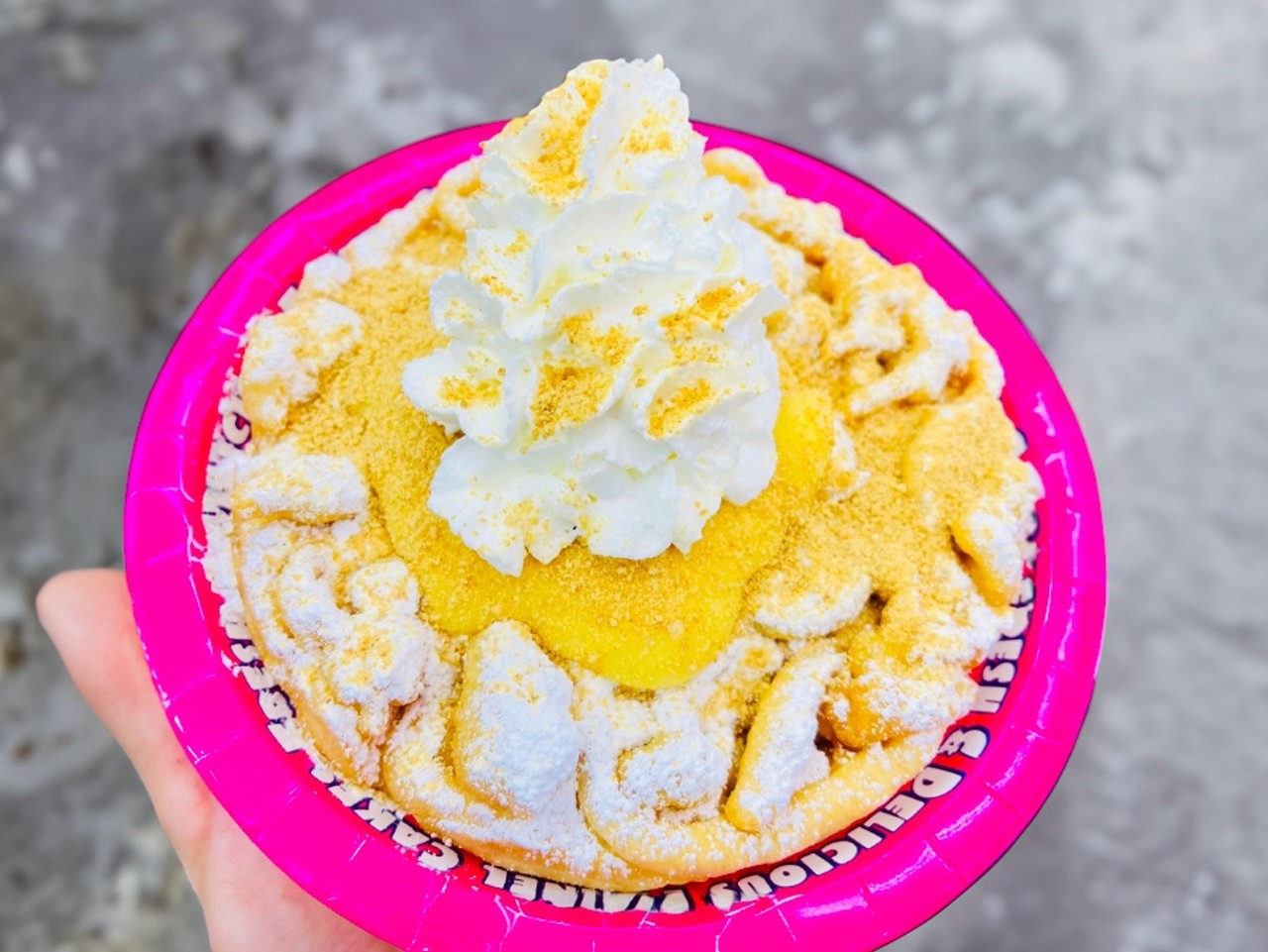 Banana Cream Pie Funnel Cake
Fresh hot funnel cake topped with banana pudding, whipped cream and graham cracker crust.
Location: Ryals Concessions Sweet Shop