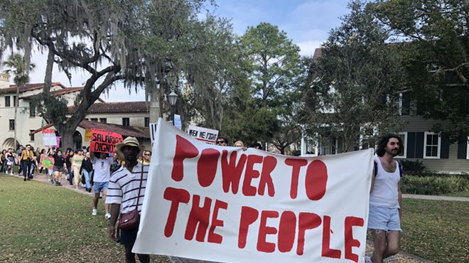 Students and faculty at Rollins College march in support of dining workers' right to organize.