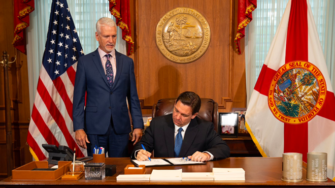 Ron Desantis signs education bill alongside Florida Sen. Keith Perry, who represents Alachua County.