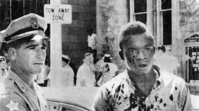Charlie Griffin, a victim of the violence in Jacksonville on August 27, 1960, is detained by police.