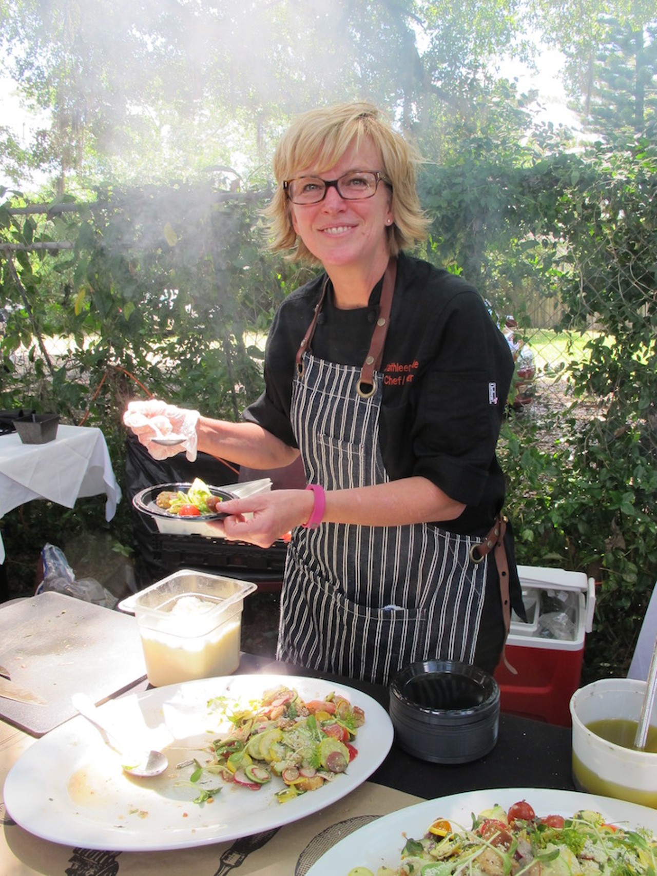 Chef Kathleen Blake of the Rusty Spoon plating summer squash and tomato panzanella with almond crumbs and ramp vinaigrette