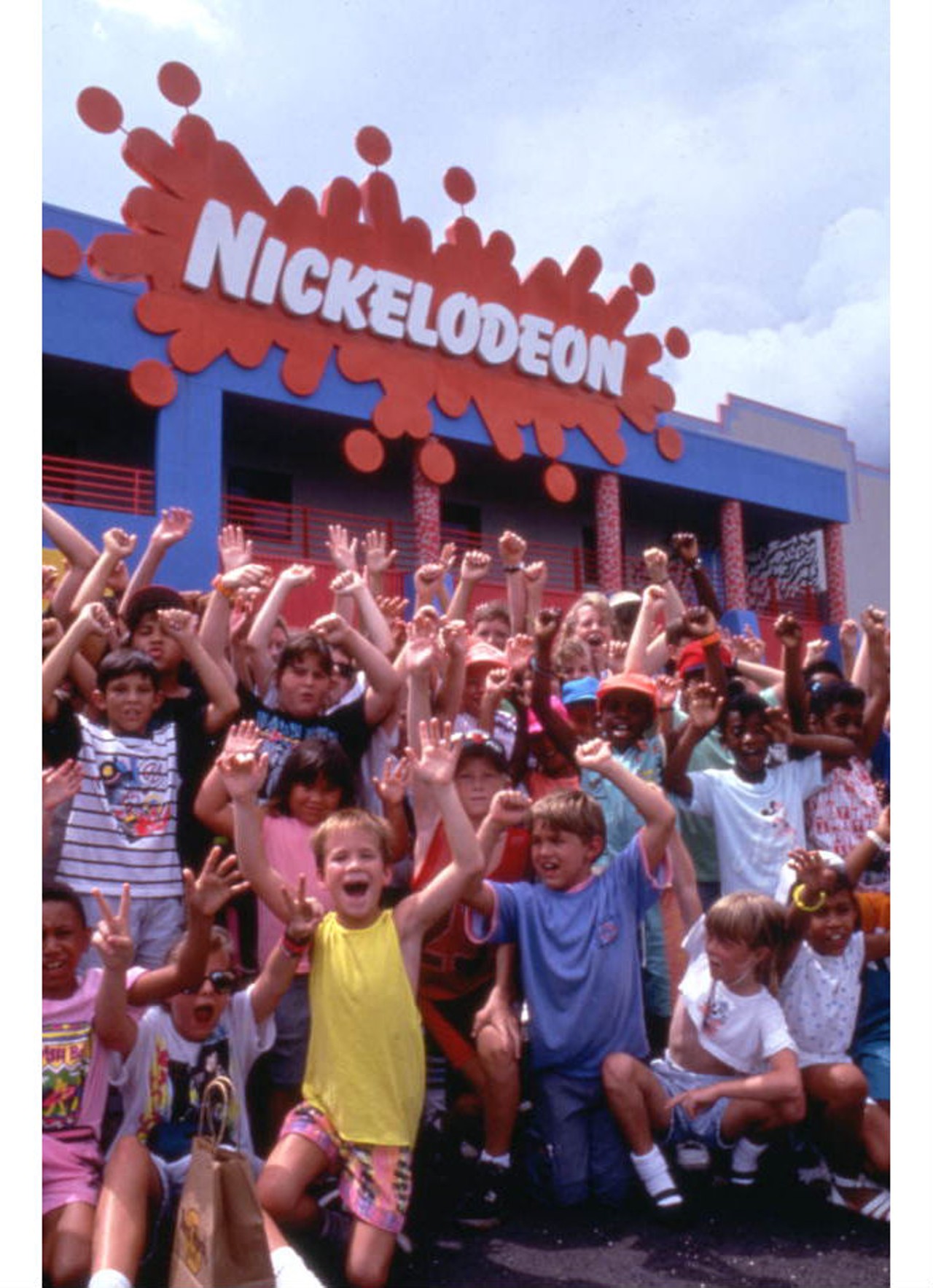 Group portrait of young visitors outside the Nickelodeon Studios attraction.via