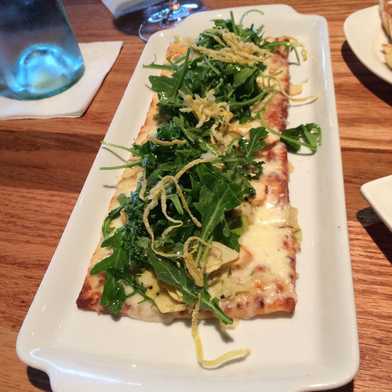 Chicken and artichoke flatbread topped with arugula and candied lemon zest from Carmel Caf&eacute;