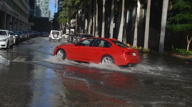 A car drives through flooded streets in Miami