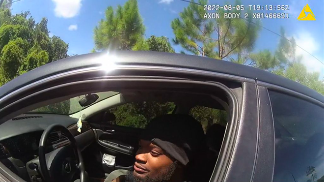 In a screenshot from a sheriff's body camera video, Darius Jermaine Ned Thomas Jr., 22, of Jacksonville, Florida, leans out his driver's window Aug. 5, 2022, to accept a $114 ticket from Jacksonville Sheriff's Office deputy M.L. Albert for playing his music too loudly. Black drivers, like Thomas, are more than three times as likely as whites to be pulled over and ticketed under the law, according to a new investigation by the University of Florida College of Journalism and Communications.