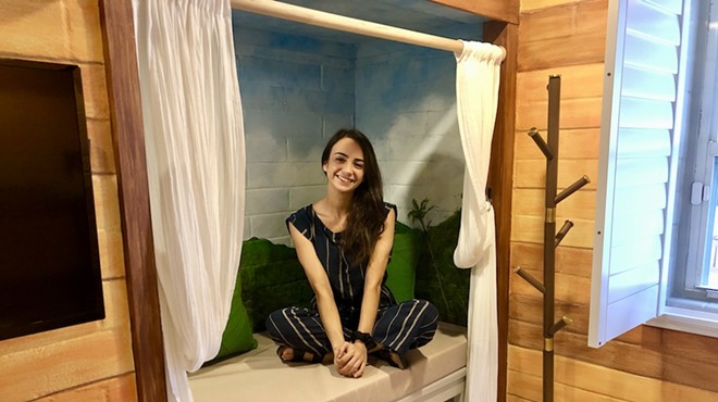 Yasmin Flasterstein, co-founder of Peer Support Space, sits in a reading nook located in a treehouse-themed bedroom for guests of Eva's Casita in Orlando.