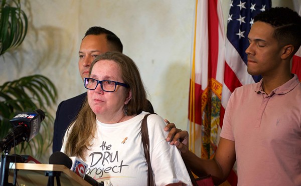 Christine Leinonen, mother of Pulse victim Christopher Leinonen, is comforted by survivor Brandon Wolf.