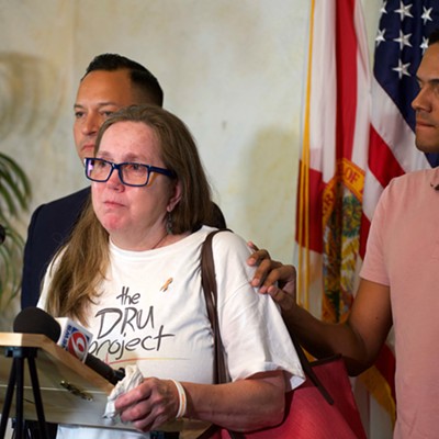 Christine Leinonen, mother of Pulse victim Christopher Leinonen, is comforted by survivor Brandon Wolf.