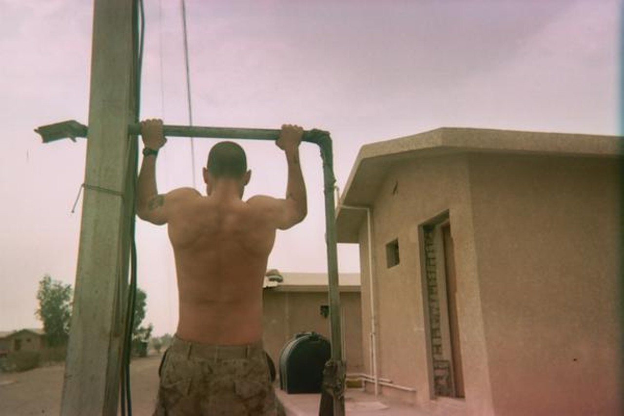 Fred performs pull-ups -- the mainstay Marine exercise -- on a makeshift bar in Camp Baharia, near Fallujah, Iraq.