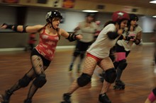 Playing nice: The Bellevue Bombshell jammer known as ‘Ellen Rage’ passes by Serial Thriller player ‘Knock’em Over Clover’ during a practice bout in October. - J. HUNTER SIZEMORE