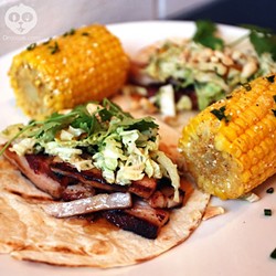 Pork belly tacos and a side of grilled corn on the cob with chili &amp; lime
