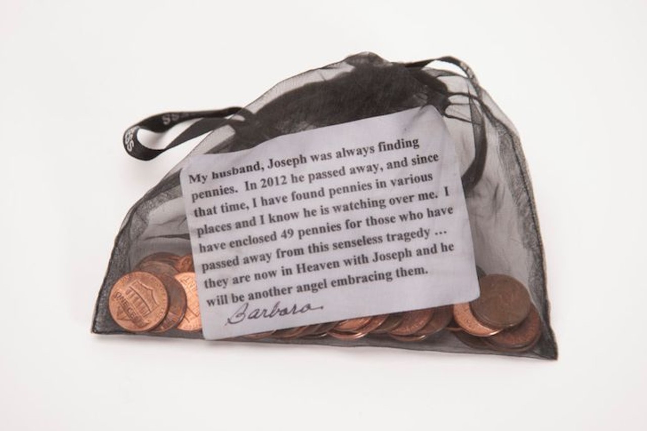 Mesh Bag with a Printed Note 
Description: 
Black mesh bag with 49 pennies and a printed message. The message says, &#147;My husband, Joseph was always finding pennies. In 2012 he passed away, and since that time, I have found pennies in various places and I know he is watching over me. I have enclosed 49 pennies for those who have passed away from this senseless tragedy&#133;they are now in Heaven with Joseph and he will be another angel embracing them.&#148;