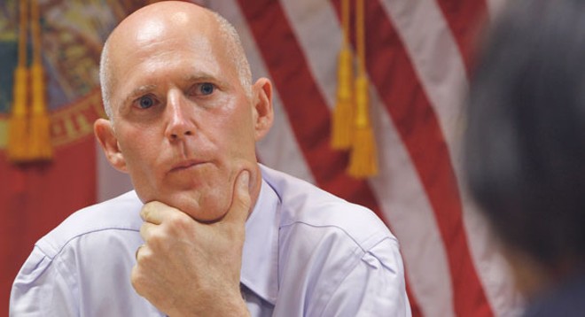 "Some hesitation": Gov. Rick Scott signs online voter registration bill, but does so with a frown