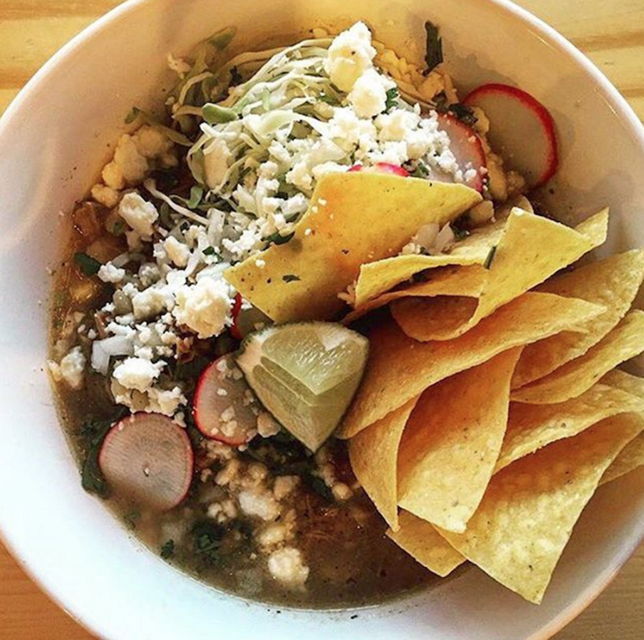 Best Way to Eat Your Greens: Pozole Verde at Black Rooster Taqueria
1323 N. Mills Ave., 407-601-0994,
Black Rooster Taqueria
How many times have we heard it: "Eat your greens!" Well, our new favorite way to follow the letter, if not at all the spirit, of the law is Black Rooster's pozole verde. A big hunk of slow-cooked pork shoulder swimming in a bowl of broth all zingy with roasted tomatillo, chile poblano, cilantro and lime, it's lush and meaty without being overpoweringly unctuous. And hey, it's garnished with radish and green cabbage &#150; practically health food, right?
Photo via blkroostertaco/Instagram