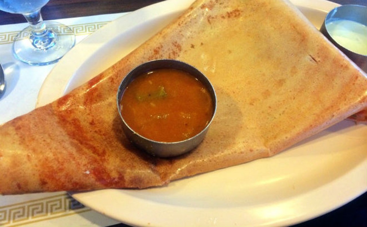Butter Masala Dosa
Woodlands, 6040 S. Orange Blossom Trail, 407-854-3330; woodlandsusa.com
The thinnest, crunchiest rice-flour crepe wraps around a soft, complexly spicy filling of potatoes and onions cooked in butter. Slather liberally with green-chili-hot coconut chutney.
Pic via Yelp