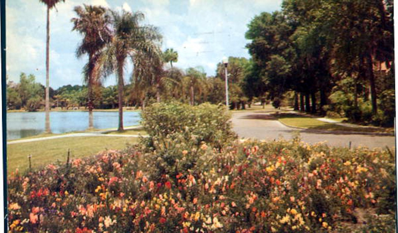 Flowers and trees line the drive along Lake Eola in Orlando, Florida, published sometime in the 1900s.