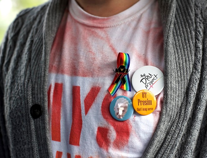 David Moran, who leads the Orlando chapter of Gays Against Guns, shows his buttons on a bus to Tallahassee. - PHOTO BY MONIVETTE CORDEIRO