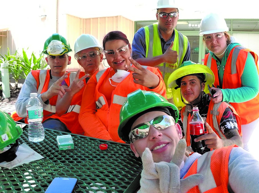 Maria “Betzy” Santiago Burgos, second from left, at her construction job - Photo via Desiree Torres