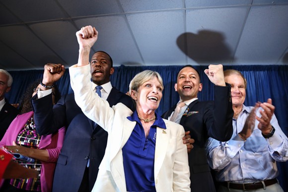 Florida Democratic Party chairwoman Terrie Rizzo chants "Bring it home!" with gubernatorial nominee Andrew Gillum (left), State Rep. Carlos Smith, and U.S. Sen. Bill Nelson (far right) to conclude a Democratic victory rally in Orlando on Aug 31 2018. - PHOTO BY JOEY ROULETTE