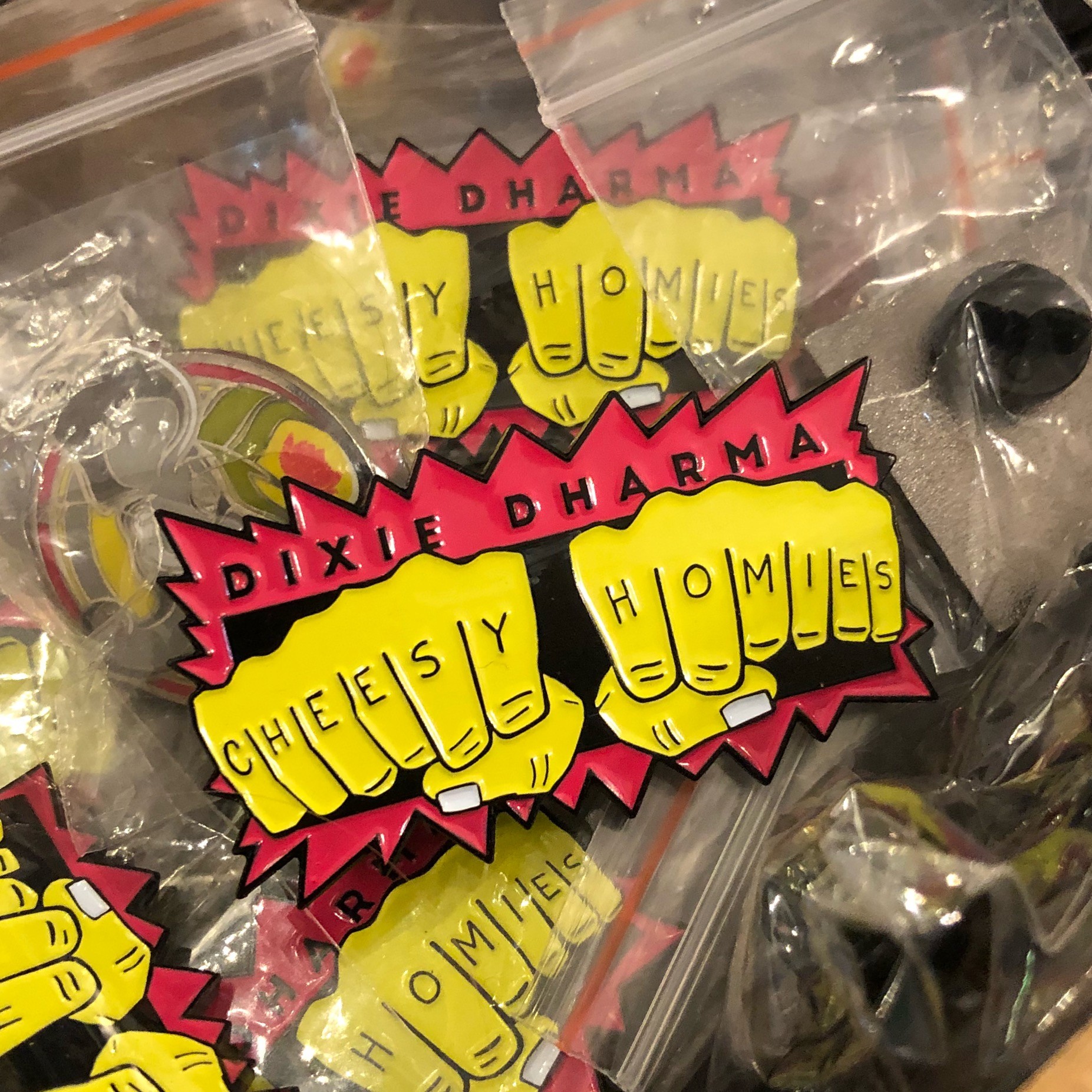 Dixie Dharma "Cheesy Homies Knuckle Tat" enamel pin - PHOTO BY JESSICA BRYCE YOUNG